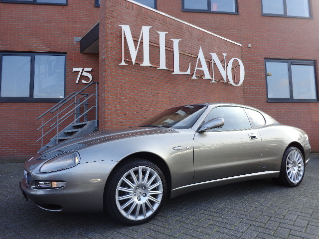 Een bijzonder mooie Maserati 4200 coupe, in middengrijs metaal met donkerblauw lederen interieur. Beweeg met uw muis over de afbeelding, om het prachtige interieur te zien.